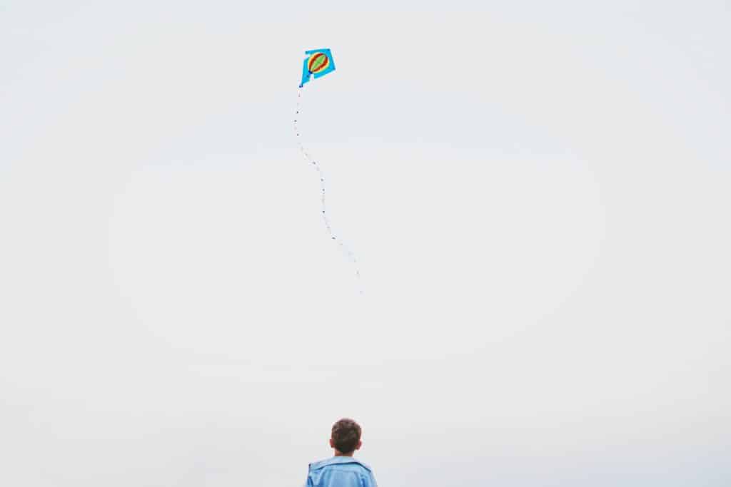 boy flying a kite | fun ways to add more play into your life this spring | Eat. Drink. Work. Play.
